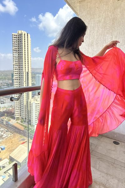 Pink Satin Silk Printed Blouse with matching Georgette Printed Sharara and Georgette Cape with Crystal work.